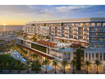 Stunning exterior of an oceanfront resort with multiple pools, restaurants, and palm tree landscaping at 15000 Madeira Way # 510, Madeira Beach, FL 33708