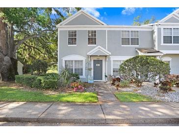 Charming townhome with a well-manicured lawn, tasteful landscaping, and inviting curb appeal at 2418 Lake Woodberry Cir, Brandon, FL 33510