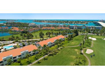 Beautiful aerial view of resort condos with golf course, tropical landscaping, and waterfront views at 6191 Bahia Del Mar Blvd # 204, St Petersburg, FL 33715