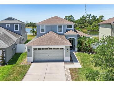 Charming two-story home featuring a two-car garage, neutral paint, and well-manicured lawn at 7207 Forest Mere Dr, Riverview, FL 33578