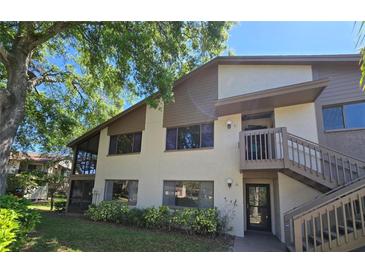 Two-story condo featuring a screened patio, private entrance, and well-maintained landscaping at 12809 Wedgewood Way # A, Hudson, FL 34667