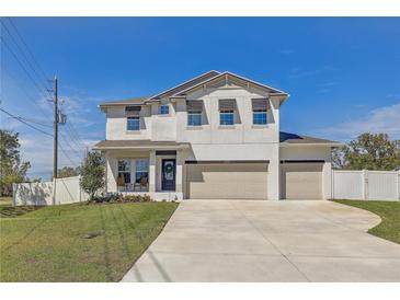 Charming two-story home with a three-car garage, well-manicured lawn, and bright exterior at 2190 Fairway S Ave, St Petersburg, FL 33712