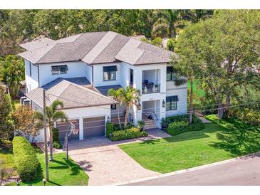 Stunning two-story home with a manicured lawn, a two-car garage, and a beautiful walkway leading to the front entrance at 2501 S Dundee St, Tampa, FL 33629