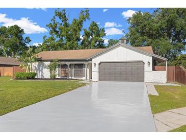 Charming single-story home featuring a large two-car garage and well-maintained landscaping at 2719 Cypress Hollow Ct, New Port Richey, FL 34655