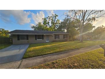 Charming single-story home with a well-maintained front yard and mature trees at 3009 S Willow Dr, Plant City, FL 33566