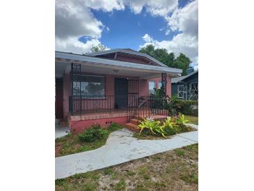 Charming single-story brick home with a covered front porch and decorative iron railings at 3607 N 13Th St, Tampa, FL 33605