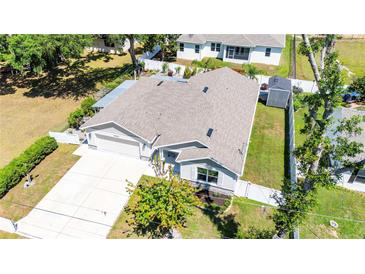 Charming single-story home with well-manicured lawn, long driveway and attached two-car garage at 37673 Dixie Ave, Dade City, FL 33525