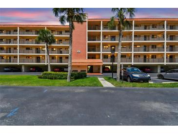 Beautiful condo complex featuring well-maintained landscaping and a view of the sunset at 9450 Harbor Greens Way # 403, Seminole, FL 33776