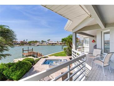 Relaxing back porch overlooking waterfront featuring a spa and an attractive view of the canal at 17382 Kennedy Dr, North Redington Beach, FL 33708
