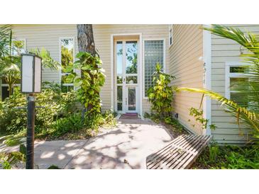 Inviting front entrance with modern windows, mature landscaping and a welcoming walkway at 6014 Luana S Ln, Gulfport, FL 33707