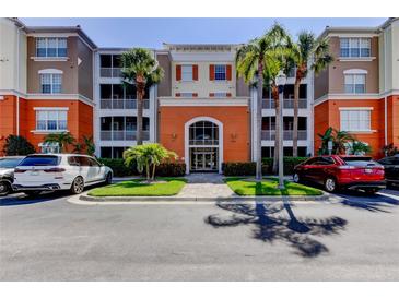 Elegant condo building exterior featuring lush landscaping, inviting entrance, and ample parking at 7903 Seminole Blvd # 2103, Seminole, FL 33772