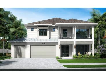 Elegant two-story home with a metal roof, spacious balcony, and lush tropical landscaping at 3911 W San Nicholas St, Tampa, FL 33629
