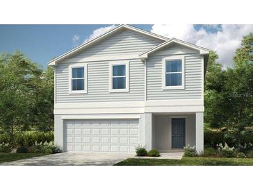 Charming two-story home with gray siding, white trim, and an attached garage at 12440 Gust Ct, Hudson, FL 34669