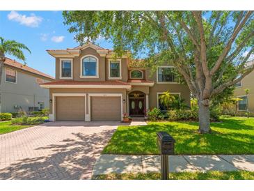 Charming two-story home with a well-maintained lawn, double garage, and a beautiful terracotta tile roof at 2671 Lakebreeze S Ln, Clearwater, FL 33759