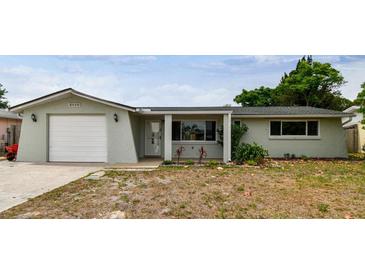 Charming single-story home with attached garage and well-maintained front yard at 5810 8Th Ave, New Port Richey, FL 34652