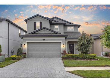 Beautiful two-story home featuring a paved driveway, two car garage and manicured front yard at 19926 Stone Pine Cir, Lutz, FL 33558