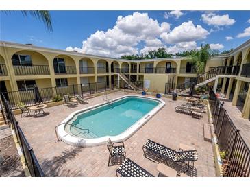 Well-maintained community pool area with lounge chairs and lush landscaping, perfect for relaxation at 3206 W Azeele St # 218, Tampa, FL 33609