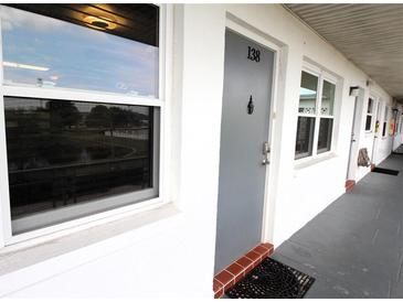 Condo front door featuring a unit number, a charming knocker, and a peek at the community at 6000 20Th N St # 138, St Petersburg, FL 33714