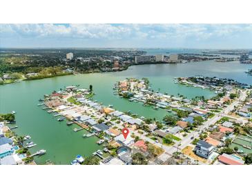Stunning aerial view showcasing waterfront homes, private docks, and vibrant city skyline in the distance at 7889 3Rd S Ave, St Petersburg, FL 33707