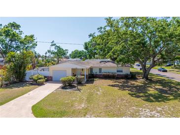 Beautiful single-story home featuring a well-kept lawn and cozy carport at 226 75Th N St, St Petersburg, FL 33710