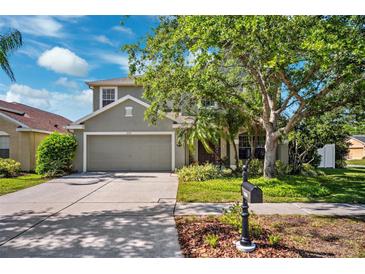 Charming two-story home featuring a well-manicured lawn and a two-car garage at 11519 Cypress Reserve Dr, Tampa, FL 33626