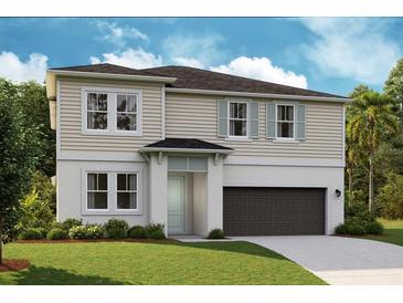 Charming two-story home with a two-car garage, neatly manicured lawn, and pleasing architectural details at 14423 Meadow Bird Ave, Riverview, FL 33579