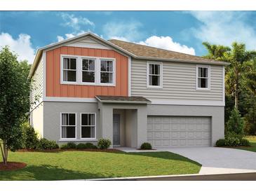 Charming two-story home with a neutral palette, attached garage, and well-manicured front lawn at 14803 Summer Branch Dr, Lithia, FL 33547