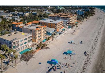 Coastal condominiums boast private pools and beach access on a sunny day, enhancing the allure of beachfront living at 3 7Th Ave # 3, Indian Rocks Beach, FL 33785