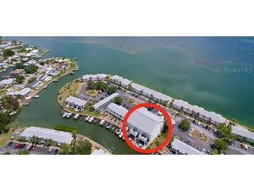 Aerial view of waterfront condos with docks and canal access to the ocean at 4799 Coquina Key Se Dr, St Petersburg, FL 33705