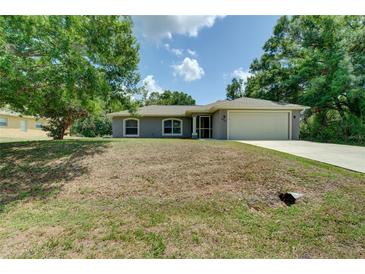 Charming single-Gathering home featuring well-maintained landscaping and a two-car garage at 3206 Shalimar Ter, North Port, FL 34286
