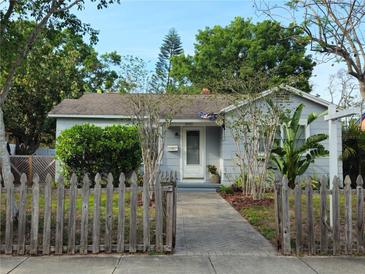 Charming single-story home featuring a well-maintained lawn and inviting front porch and quaint picket fence at 3545 7Th N Ave, St Petersburg, FL 33713