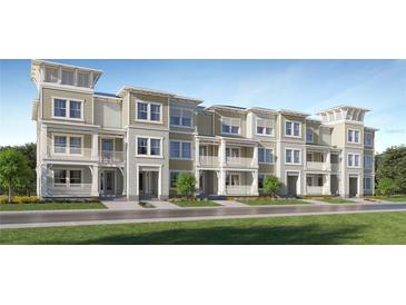 Beautiful exterior elevation of new construction townhomes with spacious balconies and charming architectural detail at 3576 Silent Gardens Cv, Wesley Chapel, FL 33543