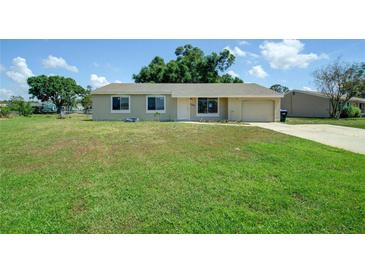 Charming single-story home with a well-maintained lawn and attached one car garage at 3262 Montclair Cir, North Port, FL 34287