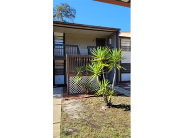 Inviting two-story condo with green lawn and manicured tropical landscaping at 11411 Pike Ct # 6, New Port Richey, FL 34654