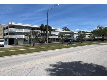 A well maintained three story condominium building with lush landscaping on a beautiful, sunny day at 4715 Bay Ne St # 235, St Petersburg, FL 33703