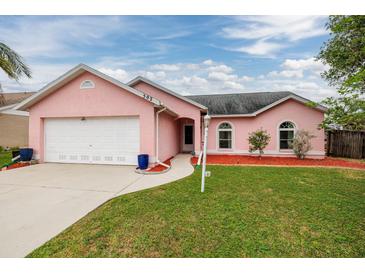 Charming single-story home showcasing a well-manicured lawn and a two-car garage at 502 36Th W St, Palmetto, FL 34221
