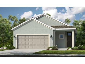 Charming single-story home featuring an attached two-car garage, neutral stucco, and a well-maintained lawn at 821 Steel Dr, Apollo Beach, FL 33572