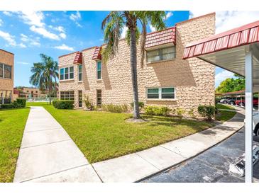 Charming two-story condo with lush landscaping and carport in a vibrant community at 101 Dogwood Cir, Seminole, FL 33777