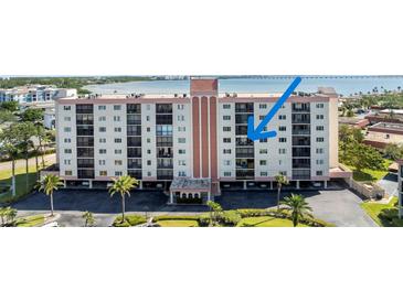 Condominium building featuring multiple floors, balconies, and water views at 19029 Us Highway 19 N # 9-407, Clearwater, FL 33764