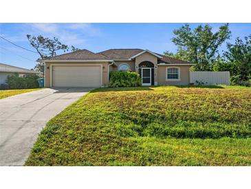 Charming one-story home with a well-maintained lawn and attached two-car garage at 7288 Castleberry Ter, Englewood, FL 34224