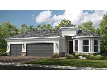 Beautiful single-story home with a three-car garage, stone accents, and a well-manicured lawn at 29936 Rusco Ct, Wesley Chapel, FL 33543