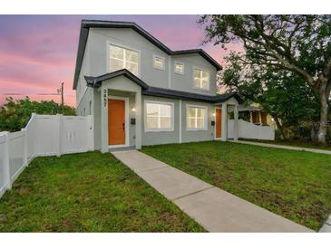 Charming two-story home featuring a well-manicured lawn and inviting entrance at 3457 17Th S Ave, St Petersburg, FL 33711