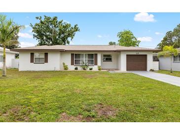 Charming single-story home with a well-manicured lawn and updated exterior at 416 Graham Dr, Clearwater, FL 33765