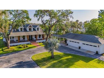 Beautifully landscaped home with a detached garage and convenient covered parking at 8013 Linesider Dr, Riverview, FL 33578