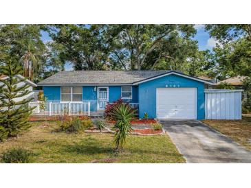 Charming blue single-story home featuring a well-maintained front yard and a one car garage at 9101 86Th Ave, Seminole, FL 33777