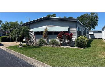 Charming single-story home with well-maintained lawn and colorful landscaping at 12501 Ulmerton Rd # 216, Largo, FL 33774