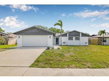 Charming single-story home with a well-manicured front yard and a two-car garage at 12641 98Th St, Largo, FL 33773