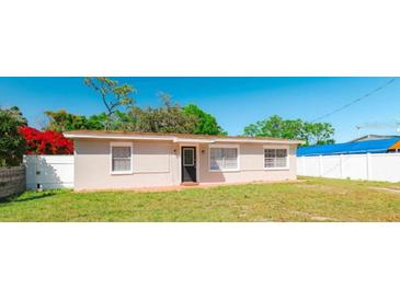 Charming single-story home featuring a well-maintained lawn and a welcoming front door at 2916 E North St, Tampa, FL 33610