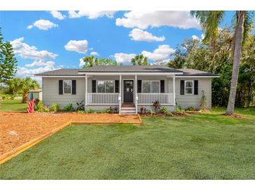 Charming single-story home with a welcoming front porch and well-manicured lawn at 602 Stephens Rd, Ruskin, FL 33570