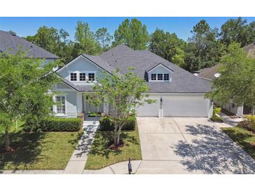 Charming two-story home boasts a well-manicured lawn and a two-car garage at 14705 Canopy Dr, Tampa, FL 33626